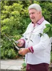  ??  ?? Pat Mulcahy cuts the ivy (ribbon) to officially open his mindfulnes­s garden at Ballinwill­in House.