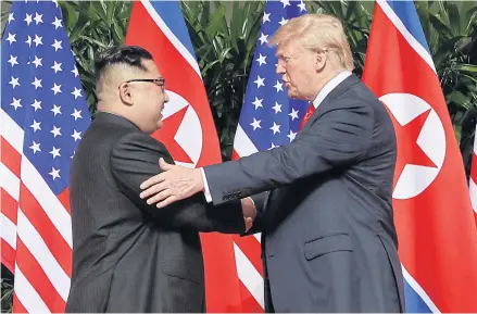  ?? AP ?? US President Donald Trump shakes hands with North Korea leader Kim Jong-un at the Capella resort on Sentosa Island in Singapore during their historic meeting on June 12 last year.