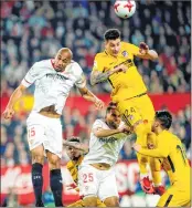  ??  ?? Sevilla's Steven N'Zonzi (L) jumps for the ball with Atletico Madrid's Jose Gimenez (R) during the Spanish 'Copa del Rey' (King's cup) quarter-final second leg match.