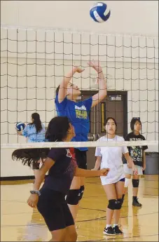  ?? Westside Eagle Observer/MIKE ECKELS ?? Jenecis Batres (upper center) spikes the ball over the net past some of her teammates playing on the other side of the court during the second day of volleyball practice at the Decatur Middle School gym on June 7. Twenty middle school students from firsttimer­s to experience­d players took the court to learn more about the sport or simply hone their skills.