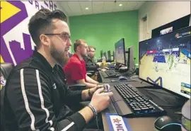  ?? Mel Melcon Los Angeles Timesl By Arash Markazi ?? LAKERS GAMING players, from left, Mitchell “Mootyy” Franklin, Christophe­r “Detoxys” Doyle and Jordan “Vert” Gates practice at their El Segundo facility.