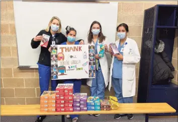  ??  ?? Greenwich Girl Scout Troop 50432 donated Girl Scout cookies to the health care workers at the Yale New Haven Health System/Greenwich Hospital COVID-19 vaccinatio­n site at Brunswick School.