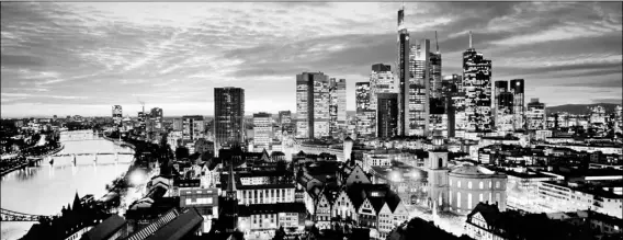  ??  ?? In this Tuesday, Feb. 12 file photo, the sun sets over the city of Frankfurt with the buildings of the banking district. AP PHOTO/MICHAEL PROBST