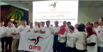  ??  ?? Rentap (front, sixth left) hands over GPS flag to Lee (front, seventh left) during a segment of the event in Miri, witnessed by (front row, from fifth left) Snowdan, Ting, Penguang and other GPS component party members. Also seen are Rosey, who stands in front of Penguang, and Dennis (right).