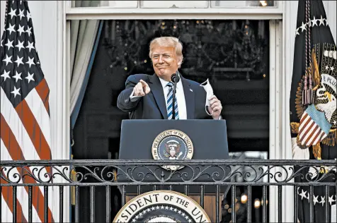  ?? SAMUEL CORUM/GETTY ?? President Donald Trump addresses a rally of several hundred people Saturday on the South Lawn of the White House.