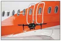  ??  ?? Bloomberg News/LUKE MacGREGOR
A drone flies around an Airbus passenger jet during a demonstrat­ion at an innovation­s event in September at London’s Gatwick airport.