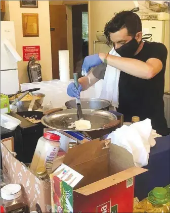  ?? (Courtesy Photo) ?? Furloughed from a job at a high-end Fayettevil­le restaurant, Alex Tripodi took his knowledge of food and started feeding those in need, creating MayDay Community Kitchen.