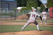  ?? ?? Woodland Christian junior pitcher Jacob Huerta throws toward home during the Cardinals' playoff game against Golden Sierra at Trafican Memorial Field on Wednesday.