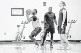  ?? MIKE STOCKER/SUN SENTINEL ?? Justice Winslow lines up his shot during practice on the second day of Heat training camp at Keiser University Flagship Campus in West Palm Beach.