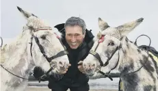  ??  ?? Guy Smith and his donkeys.
