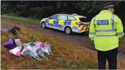  ??  ?? Tributes: Flowers are left at the crime scene yesterday