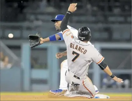  ?? Lawrence K. Ho Los Angeles Times ?? THE BALL and Gregor Blanco arrive simultaneo­usly, but Dodgers shortstop Jimmy Rollins fields throw in time for a force in third.