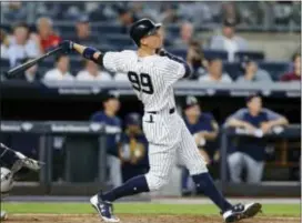  ?? KATHY WILLENS — THE ASSOCIATED PRESS ?? The Yankees Aaron Judge watches his fifth-inning solo home run against the Brewers in New York on Friday. The home run was Judge’s 30th of the season, but the Brewers won, 9-4..