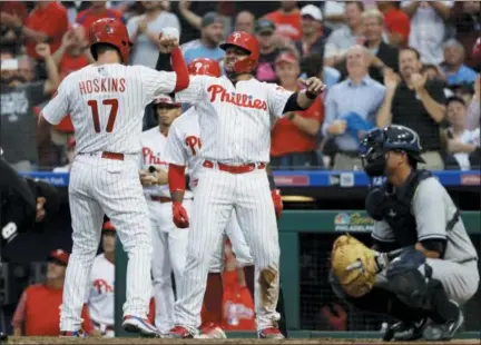  ?? MATT SLOCUM — THE ASSOCIATED PRESS ?? Philadelph­ia Phillies outfielder Rhys Hoskins, left, and Jorge Alfaro, center, celebrate after Hoskins hit a three-run home run during the second inning of Wednesday’s game in Philadelph­ia.