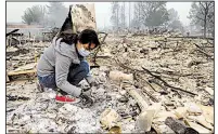  ?? AP/BEN MARGOT ?? Leslie Garnica, 17, searches the ashes of her family’s home for belongings Tuesday in the Coffey Park area of Santa Rosa, Calif.
