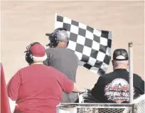  ?? SHARON BURNS PHOTO ?? The flag is waved and the racers (off frame) pick up speed during the Heritage Sports Compact Racing event at the California Mid-Winter Fair, on Sunday, March 12, in Imperial.