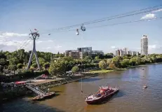  ?? FOTOS: DPA ?? Ein Mann wird aus rund 40 Meter Höhe über dem Rhein auf ein Schiff der Feuerwehr abgeseilt.