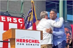  ?? AP PHOTO/BILL BARROW ?? Georgia Gov. Brian Kemp campaigns alongside Senate candidate Herschel Walker on Saturday in Smyrna, Ga.