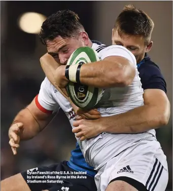  ??  ?? Dylan Fawsitt of the U.S.A. is tackled by Ireland’s Ross Byrne in the Aviva Stadium on Saturday.