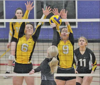  ?? Photos by Matthew Liebenberg ?? SunDogs players Amber Hansen (#6) and Ashten Miller (#9) block a return by Brooke Risling of the 18U Wildfire, March 2.