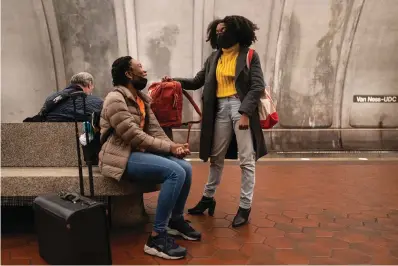  ?? The Associated Press ?? ■ Howard University School of Law students Ashley Brickhouse, left, and Jasmine Marchbanks-Owens, wait for a train on the Washington D.C. Metro Red Line after class on Feb. 3 in Washington. For Marchbanks-Owens and other Black women, President Joe Biden’s pledge to nominate a Black woman to the Supreme Court is a source of inspiratio­n that will bring needed balance and perspectiv­e to the high court.