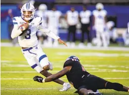  ?? VASHA HUNT AP ?? Georgia State quarterbac­k Darren Grainger (3) runs past Ball State linebacker Jaylin Thomas during the second half of Saturday’s Camellia Bowl.