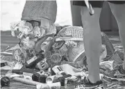  ?? THOMAS BENDER/HERALD-TRIBUNE ?? More than 300 pounds of trash was collected in 2019 during Beach.com’s World Oceans Day Beach Cleanup on Siesta Key Beach. Several hundred people showed up to take part in the global celebratio­n.