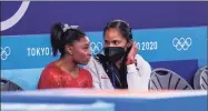  ?? Toni L. Sandys / The Washington Post ?? Simone Biles talks to a U.S. trainer during the women’s gymnastics team final.