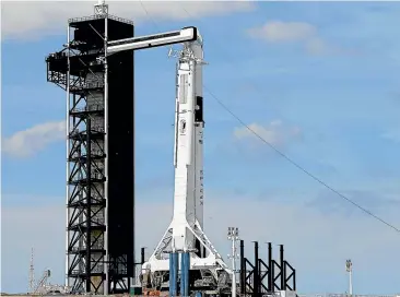  ??  ?? A SpaceX Falcon 9 rocket with an unmanned Dragon capsule sits on the launch pad at the Kennedy Space Centre in Cape Canaveral, Florida. The test flight marks the beginning of new partnershi­ps between the US Space agency and commercial firms.