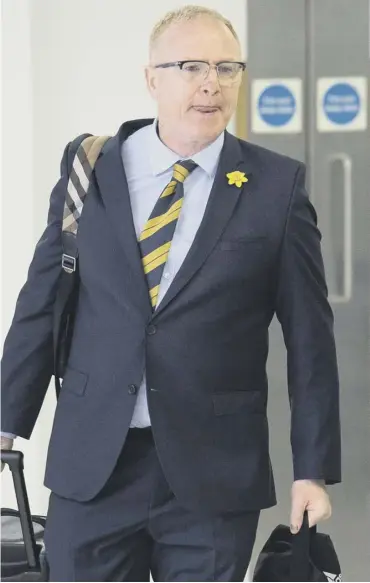 ??  ?? 0 Alex Mcleish arrives back at Glasgow Airport after Scotland’s trip to Kazakhstan and San Marino.