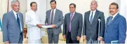  ??  ?? Bond Commission members handing over their comprehens­ive report to President Sirisena yesterday.