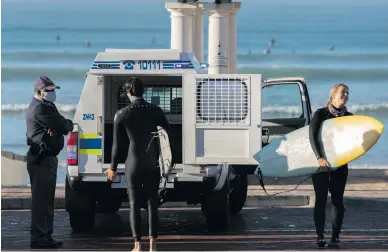  ?? Picture: EPA-EFE ?? Two surfers were arrested and later released in Cape Town yesterday. South Africa’s lockdown regulation­s were eased as yesterday as part of a phased risk adjusted strategy by government.