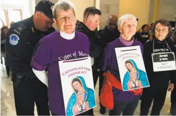  ?? Saul Loeb / AFP / Getty Images ?? U.S. Capitol Police arrest Catholic nuns rallying in the Senate office building to support recipients of Deferred Action for Childhood Arrivals, or “Dreamers.”