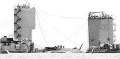  ??  ?? Workers prepare to lift the sunken Sewol Ferry in waters off Jindo, South Korea, on March 23.