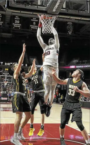  ?? GENE WALSH — DIGITAL FIRST MEDIA ?? Plymouth Whitemarsh’s Naheem McCleod dunks the ball surrounded by a host of CB West Tuesday night.