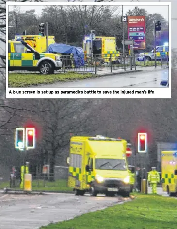  ??  ?? A blue screen is set up as paramedics battle to save the injured man’s life
The air ambulance in Simone Weil Avenue next to Warren Retail Park in Ashford after a