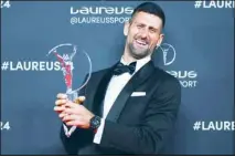 ?? ?? Serbian tennis player Novak Djokovic poses for the media after winning “Sportsman of the year 2024” at the Laureus Sports Awards ceremony in Madrid. (AP)