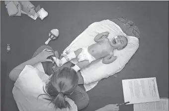  ?? FELIPE DANA / ASSOCIATED PRESS ?? Jose Wesley Campos, who was born with microcepha­ly, cries during his physical therapy session at the AACD rehabilita­tion center in Recife, Brazil. Jose has vision and breathing problems and is severely underweigh­t at 5.8 kilograms.