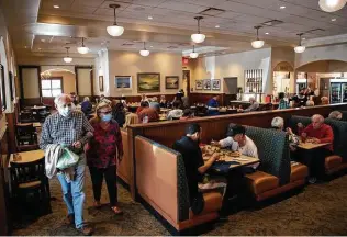  ?? Godofredo A. Vásquez / Staff file photo ?? Customers eat lunch at Cleburne Cafeteria on March 18 in Houston. Restaurant­s are allowed to fully reopen after Gov. Greg Abbott lifted restrictio­ns and the mask mandate last month.