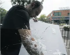  ?? CRAIG ROBERTSON / POSTMEDIA NEWS ?? Pictured are a pair of gaping bullet holes in the window of the Second Cup on Danforth Ave., on Monday.