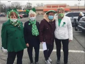  ?? PEG DEGRASSA - MEDIANEWS GROUP ?? Friends, left to right, Kathy Condiff, Carole Dougherty, Claire Zimmer and Judi Haines, socialize in the parking lot of Home Depot Wednesday while waiting for dozens of other well wishers to show up to form a car parade down MacDade Boulevard to surprise Schoolhous­e Center Director Kim McDonald who is retiring after 25 years of dedicated service.