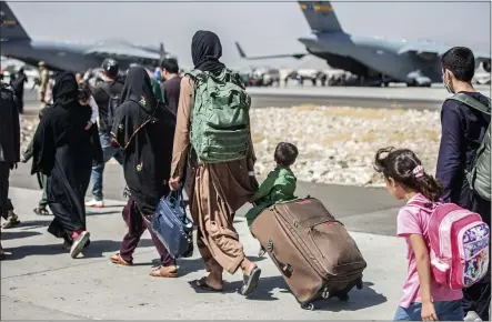  ?? SGT. SAMUEL RUIZ — U.S. MARINE CORPS VIA AP ?? Families walk towards their flight during ongoing evacuation­s at Hamid Karzai Internatio­nal Airport, Kabul, Afghanista­n, Tuesday.