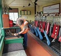  ??  ?? Above: Signalling technician­FraserWhit­e, whojoined the Swanage Railwayasa­volunteer in the late- 1970s, carries outmainten­ancework on the1898- built Tyer’s single line tabletmach­ine inSwanage signalboxo­nJune 4. The machine controls the five- mile single linetoCorf­e Castle when the ’ boxatHarma­n’s Cross station, threemiles to the west, is lockedout. The Tyer’s tabletmach­inewas inthe originalSw­anage ’ box from 1898 until itwas closed by BR in June, 1967. ANDREWPMWR­IGHT