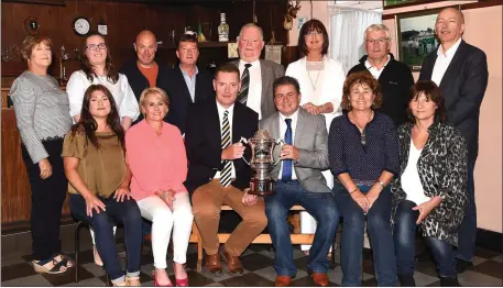  ?? Photo by Michelle Cooper Galvin ?? Finbarr Coffey (seated fourth from left0 presenting the James Coffey Memorial Cup on behalf of the Coffey family Killorglin for the Kerry County U21 Championsh­ip to Tim Murphy Chairman Kerry County Board with (front from left) Hazel, Carina, Aileen and...