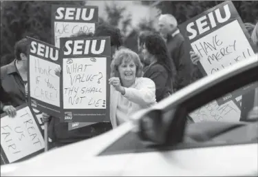  ?? Michael Allen Blair/MBlair@MorningJou­rnal com ?? Carol Hensley, a hospital worker of Lorain pickets with other members of (SEIU) District 1199 in front of Mercy Regional Medical Center in Lorain on Oct. 6.. The Union and it’s representa­tives are protesting for a fair contract. Experience the event at...