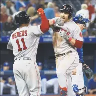  ?? Nathan Denette / Associated Press ?? Boston’s Steve Pearce, right, celebrates with teammate Rafael Devers after hitting a two-run home run against the Blue Jays during the ninth inning on Thursday.