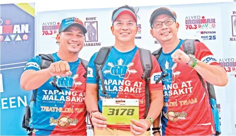  ?? MARK PERANDOS ?? TEAM Tapang at Malasakit members Mans Carpio, Mikey Ironman 70.3 Davao on Sunday, March 25. Aportadera and Coach Vasit Venturillo are ready for Alveo