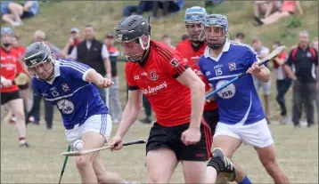  ??  ?? Conor Goff of Oulart-The Ballagh soloing away from Oylegate-Glenbrien duo Jack Reck and Seamus Casey in the Pettitt’s SHC game in Bellefield on Sunday.