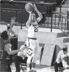  ?? PAUL W. GILLESPIE/CAPITAL GAZETTE ?? Navy’s Cam Davis, seen making a 3-pointer during Saturday’s game against Bucknell at Alumni Hall in Annapolis, drained a go-ahead jumper with five seconds left then added a pair of free throws to lead the Mids past the Bison again on Sunday.