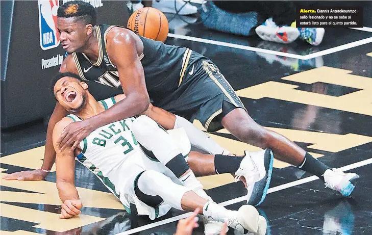  ??  ?? Alerta. Giannis Antetokoun­mpo salió lesionado y no se sabe si estará listo para el quinto partido.